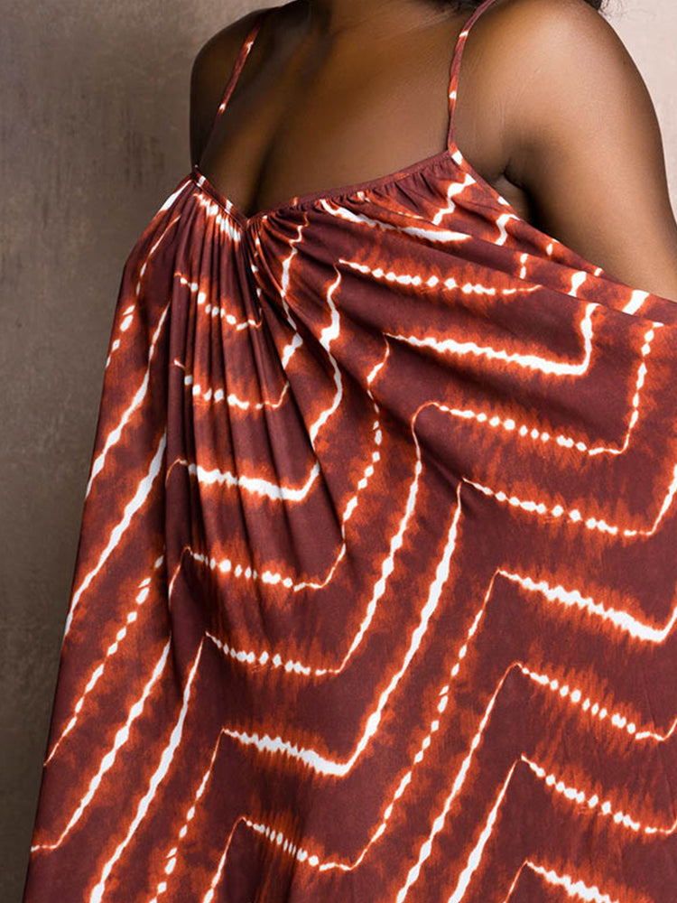 Close-up of the bodice of a brown and white tie-dye print maxi dress, showing the gathered neckline and spaghetti straps.