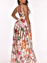 Back view of a woman wearing a white floral and striped maxi dress.