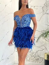 Woman posing in a royal blue sequined and feathered mini dress.