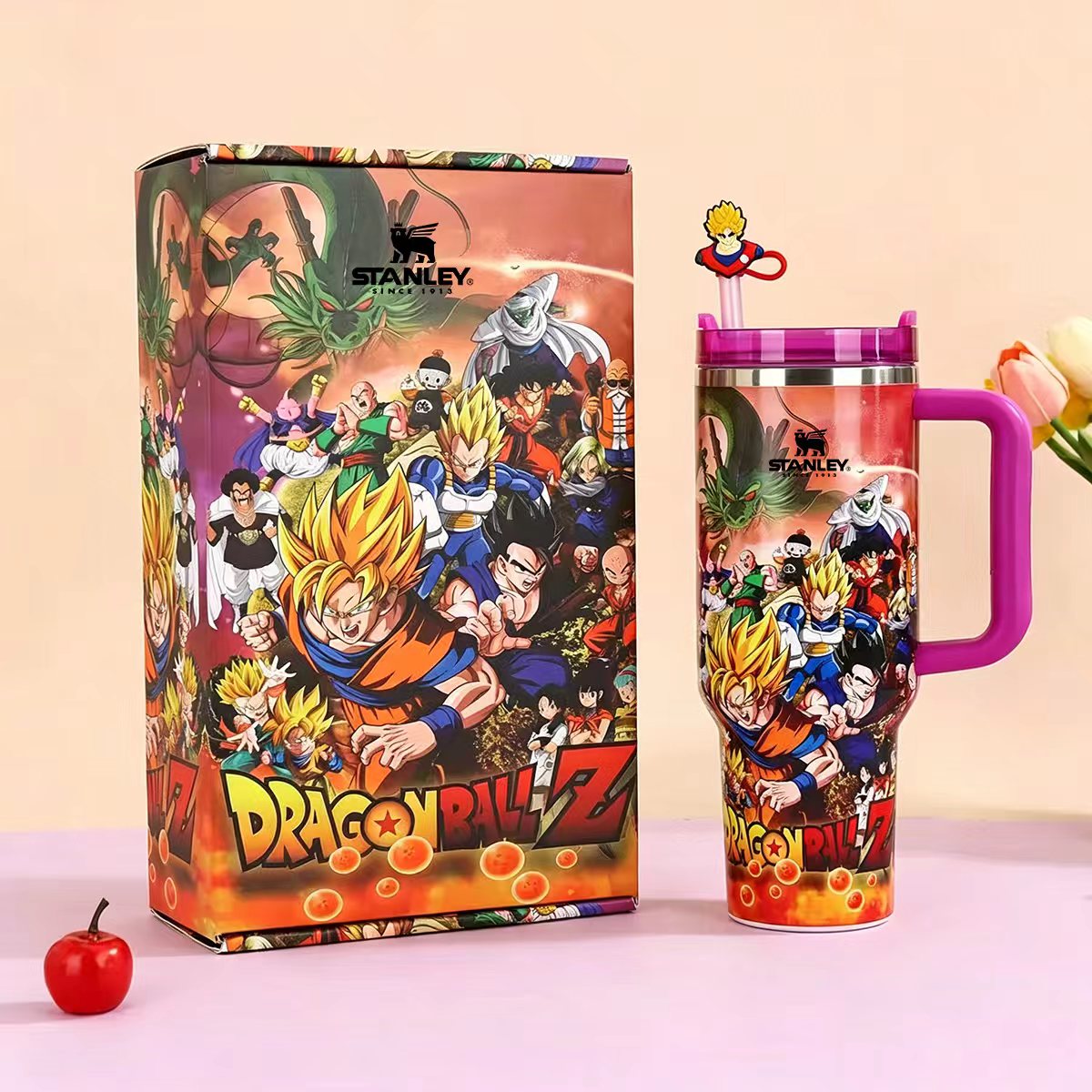 Stanley 40oz insulated tumbler featuring Dragon Ball Z characters in vibrant action scene, matching Dragon Ball-themed gift box, pink handle