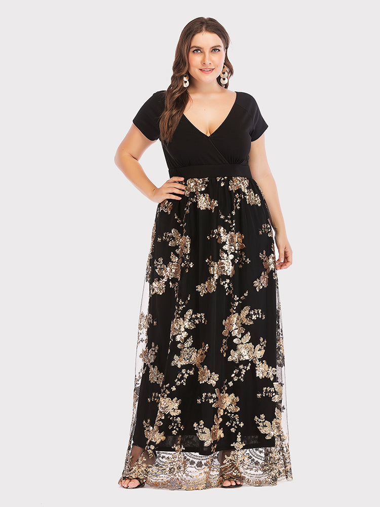Front view of a plus-size model in a black and gold sequined maxi dress, posing with one hand on her hip