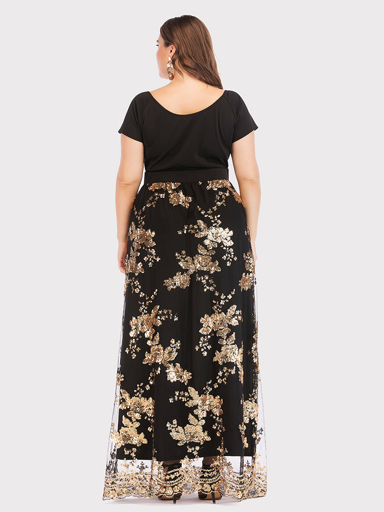 Back view of a plus-size model in a long black dress adorned with gold sequined floral patterns