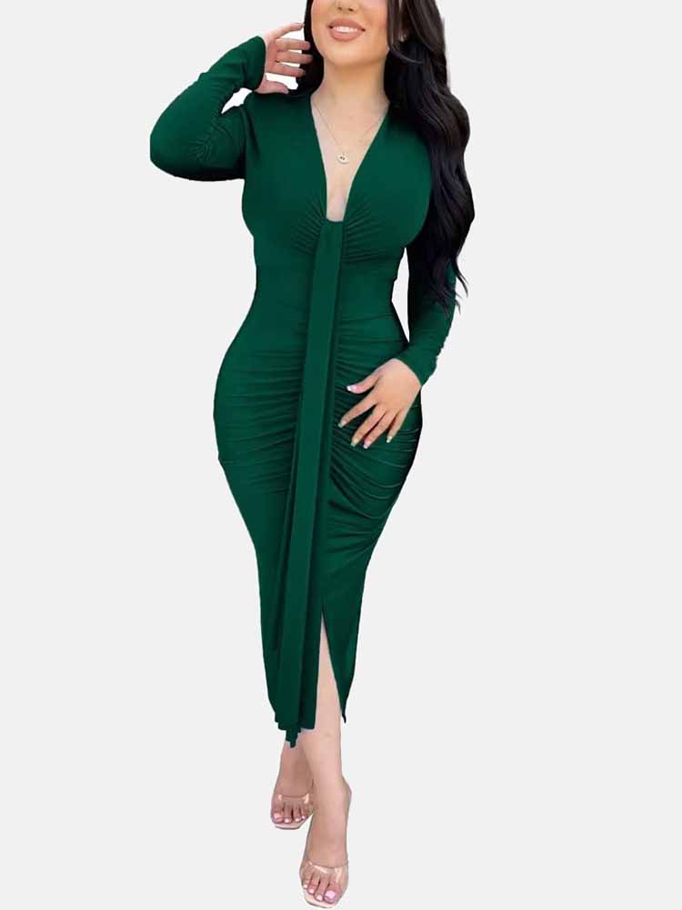 Woman wearing a long-sleeved green ruched dress with a deep V-neckline and a tie-front detail.