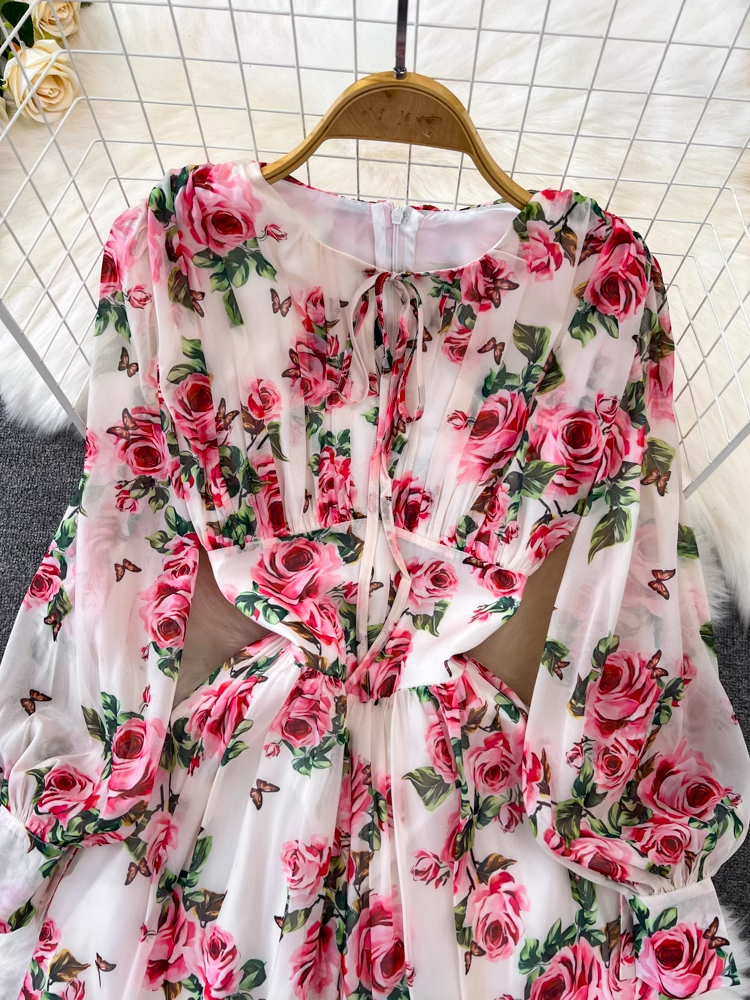 Close-up of the bodice of a floral print chiffon dress, showing the tie-neck detail and gathered fabric.