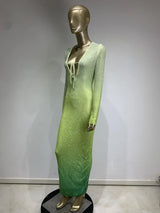 Side view of a mannequin showcasing a long, gradient green rhinestone-embellished dress with a plunging neckline.