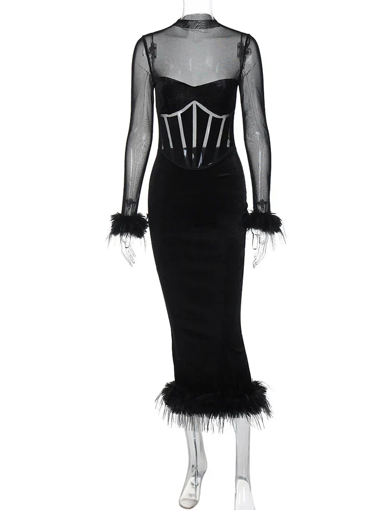 Black velvet midi dress with sheer sleeves and feather trim on a mannequin