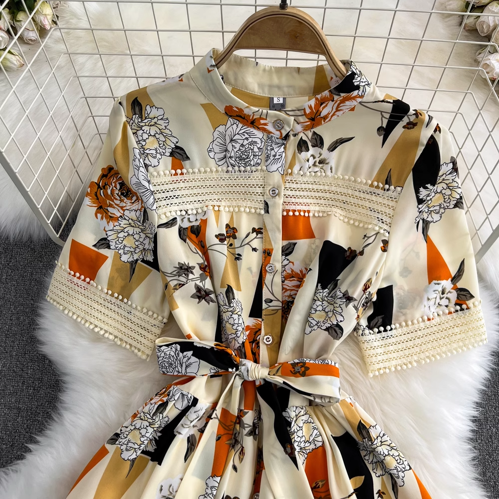 Close-up of the bodice and sleeves of a floral and geometric print maxi dress.