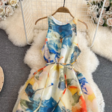 Close-up of the bodice and tie waist of a sleeveless abstract floral print maxi dress.