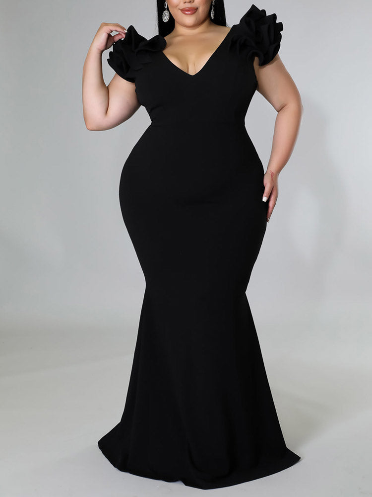 Side view of a plus-size model wearing a black mermaid dress.