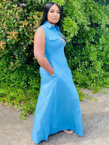 Side view of a woman in a blue denim maxi dress, showcasing the fit and pockets.