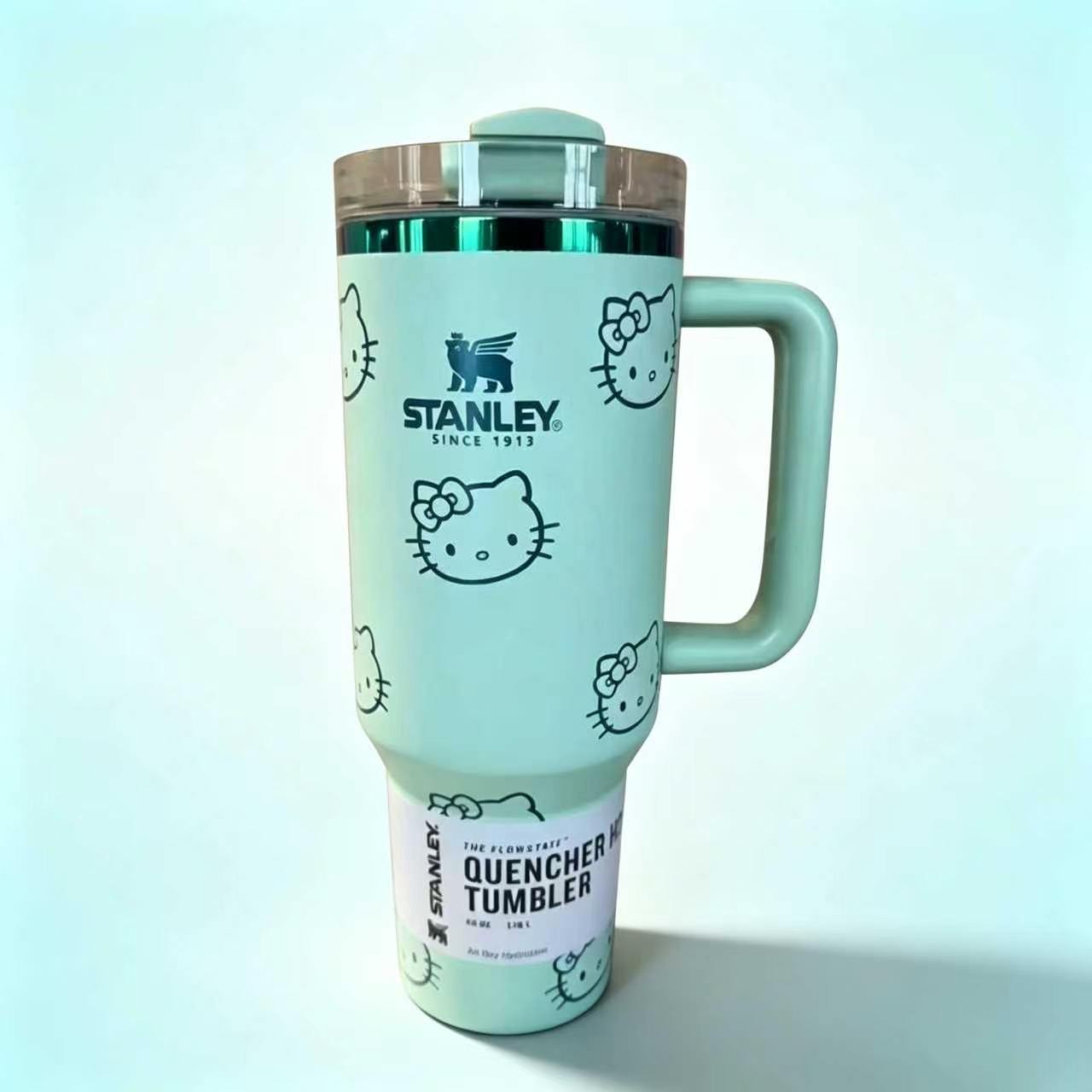 Stanley 40oz insulated tumbler with Hello Kitty full-face pattern on pink background, light pink handle