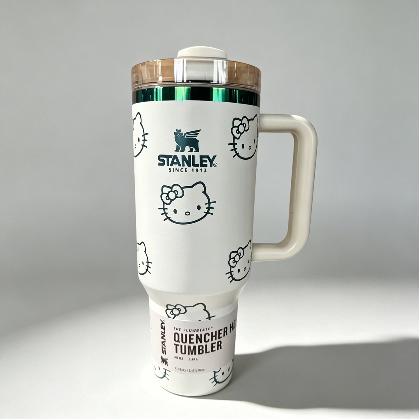 Stanley 40oz insulated tumbler with Hello Kitty full-face pattern on pink background, light pink handle