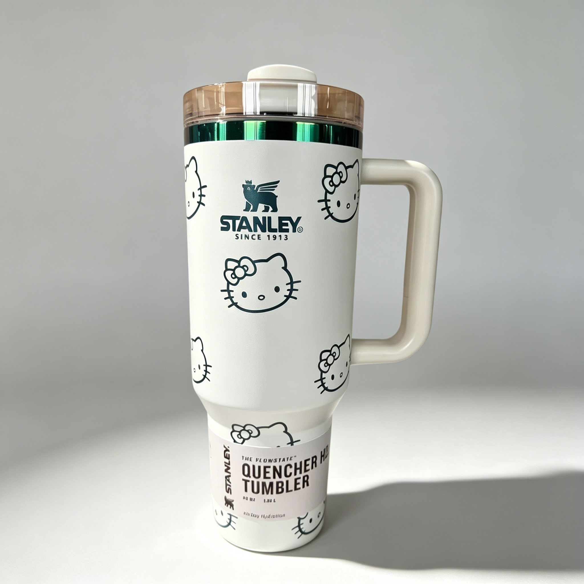 Stanley 40oz insulated tumbler with Hello Kitty full-face pattern on pink background, light pink handle