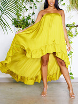 Woman modeling a strapless lime green satin high-low maxi dress with ruffle trim, showing the flow of the fabric.