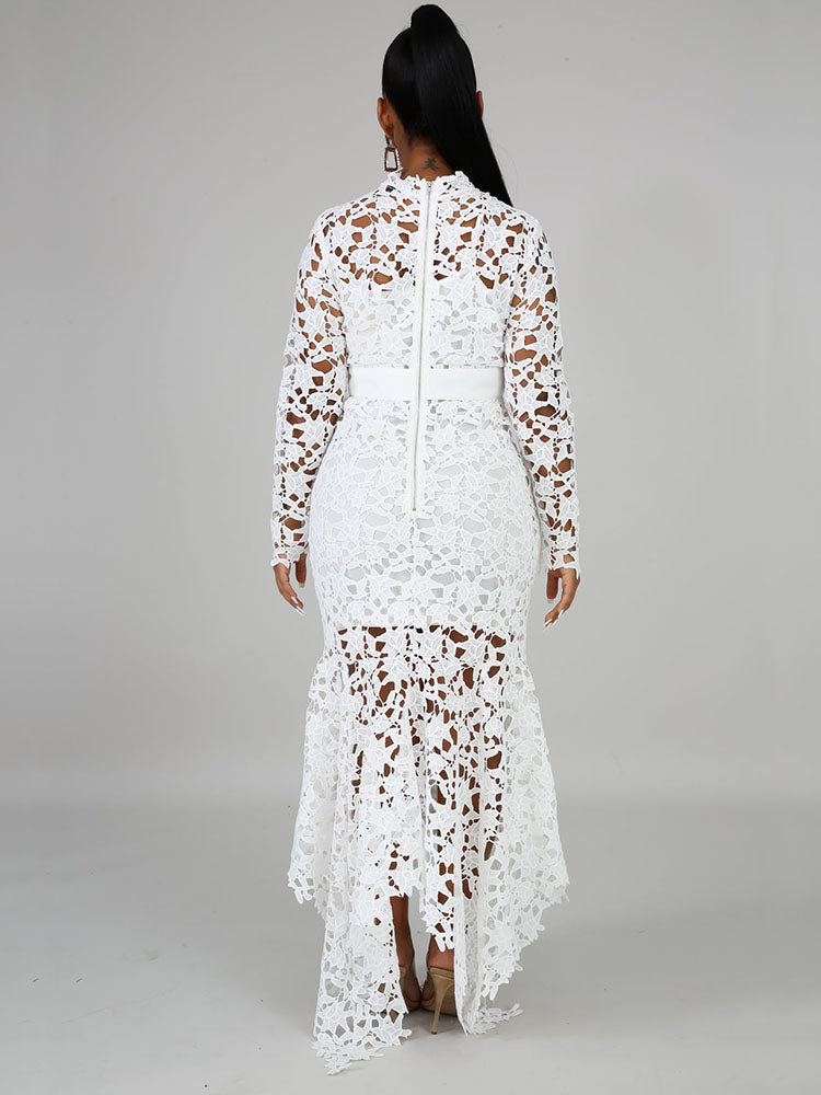 Back view of a woman wearing a white long-sleeved lace mermaid dress with a high neckline and a sash.