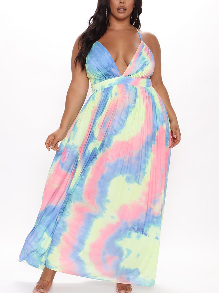 Plus-size woman wearing a tie-dye maxi dress with a plunging neckline and pleated skirt.