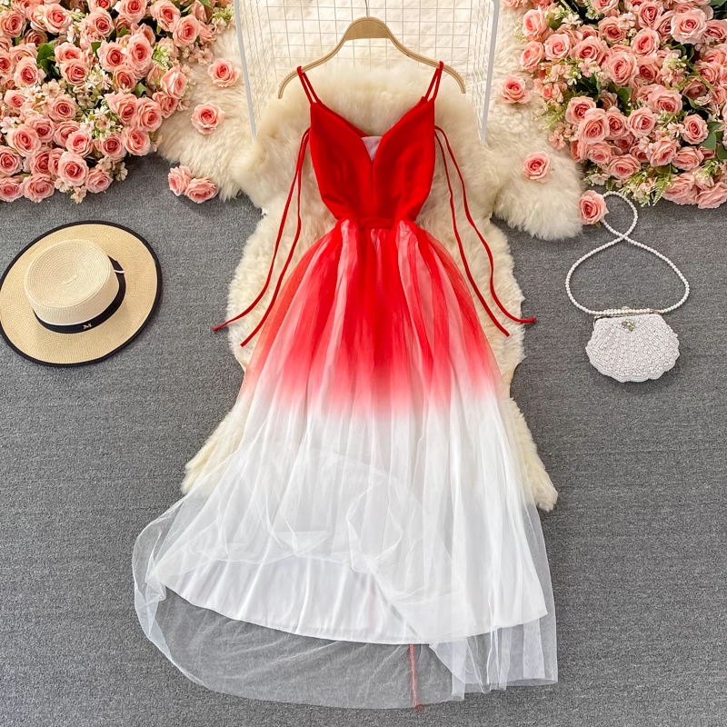 Red and white gradient tulle dress with spaghetti straps, a straw hat, and a beaded clutch