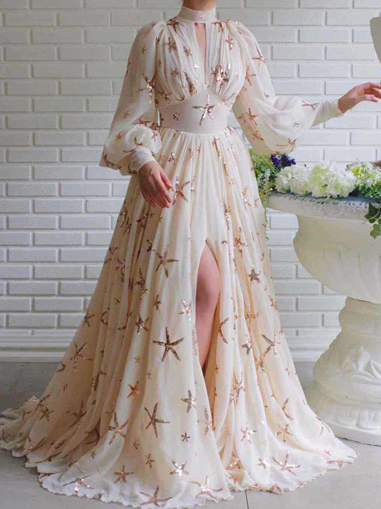 Full-length view of a woman wearing a white chiffon gown with starfish sequin embellishments.