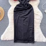 Detail of the ruched skirt and slit on the black dress