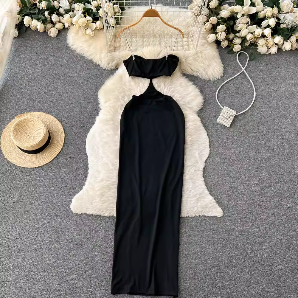 Overhead view of a black maxi dress with a halter neckline and high slit.