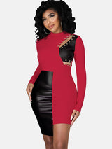 Woman wearing a red and black faux leather color-blocked bodycon dress with a mock neck and chain detailing on the shoulder.