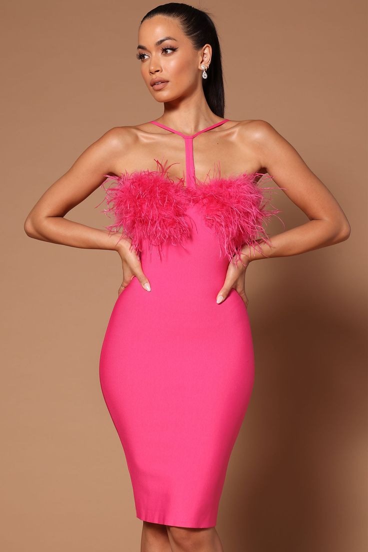 Close-up of the front of a hot pink bandage dress with feather trim and halter neckline