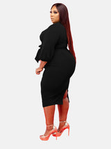Side view of plus-size black V-neck wrap dress with puff sleeves and self-tie belt