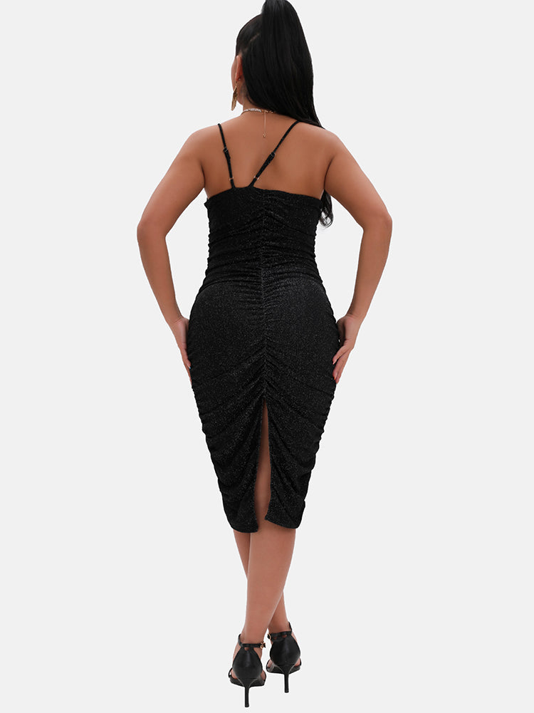 back view of a model in a black shimmering ruched midi dress with a back slit