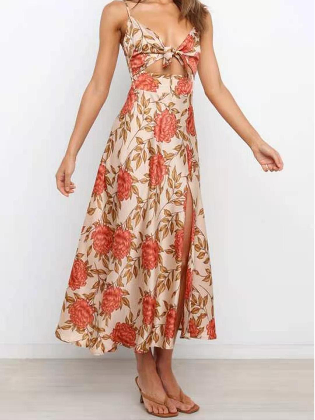 Full-body view of a woman in a floral print midi dress with cut-out detail.
