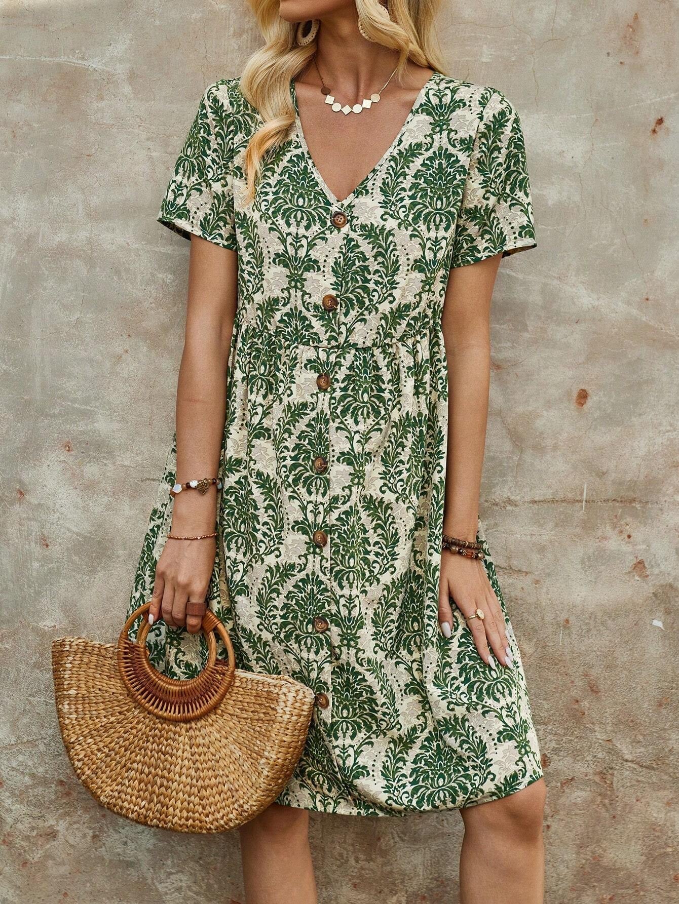 Close-up of a woman in a green and white floral print midi dress with a button-down front and V-neck, holding a straw handbag.