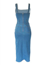 Back view of a blue denim midi dress with a square neckline and a high slit, showing the zipper.