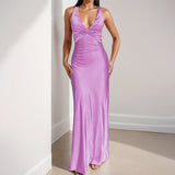 Lavender satin maxi dress with a twisted halter neckline and flowing skirt