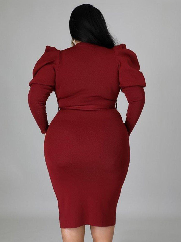 Back view of a burgundy midi dress with long puff sleeves and a fitted silhouette