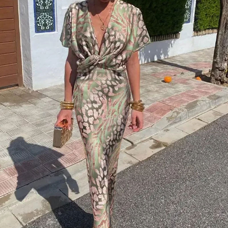 Close-up of the green and pink animal print satin maxi dress, showing the V-neckline and twisted front.