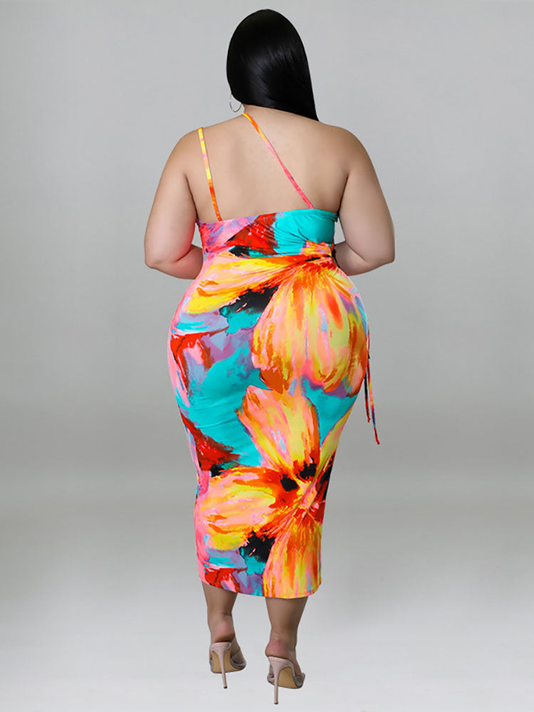 Plus-size woman wearing a colorful floral print halter neck bodycon midi dress with cut-out details and a tie waist, back view