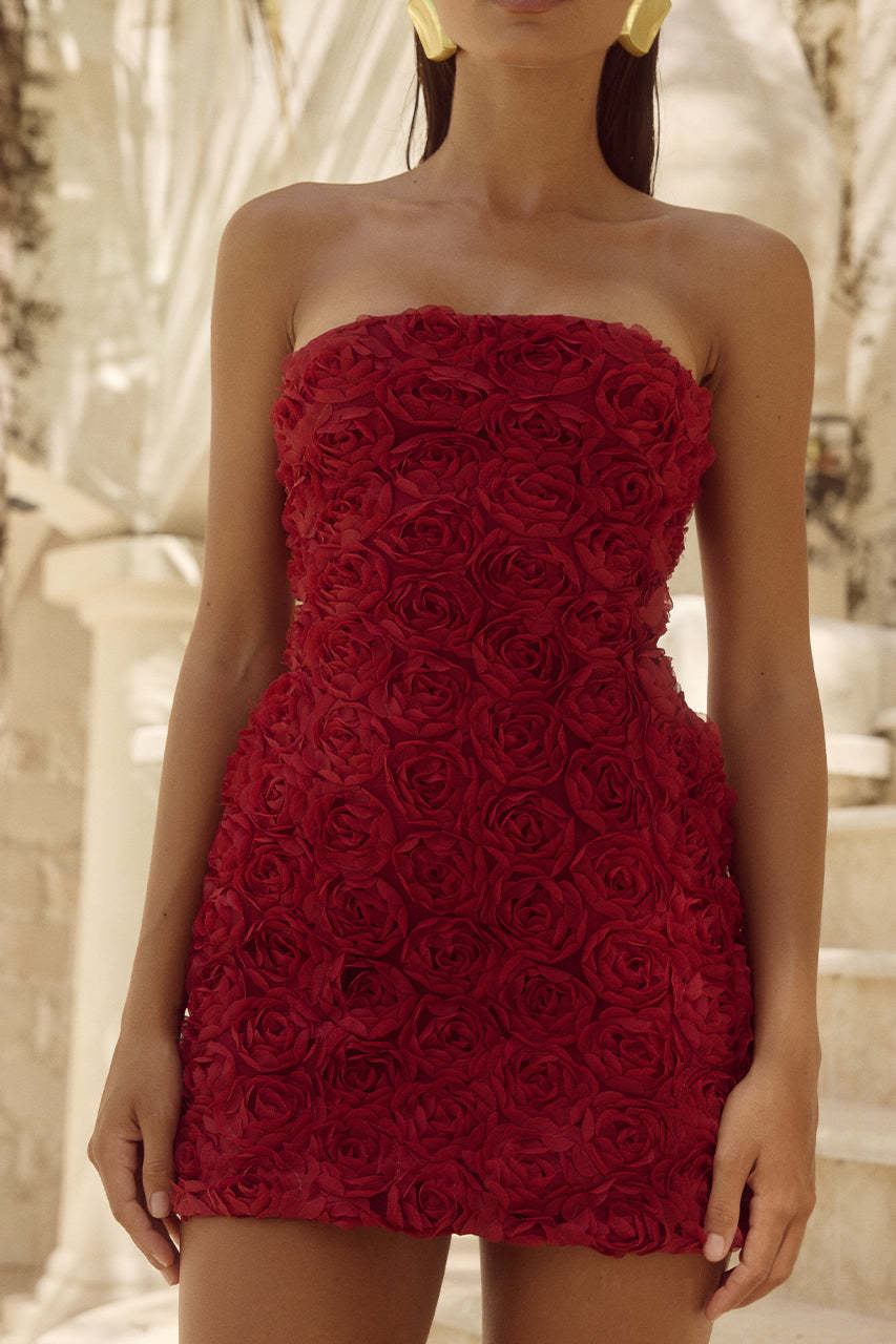 Close-up of a red strapless dress with intricate rose detailing