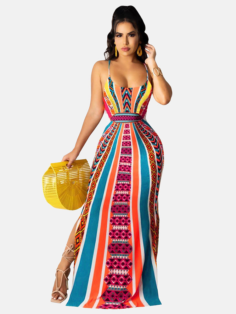 Woman wearing a colorful geometric print maxi dress with spaghetti straps and a side slit, holding a yellow fan-shaped bag.