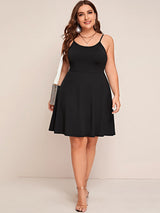 Plus size black spaghetti strap A-line dress with a silver handbag