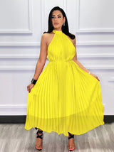 Woman showcasing a yellow pleated halter dress
