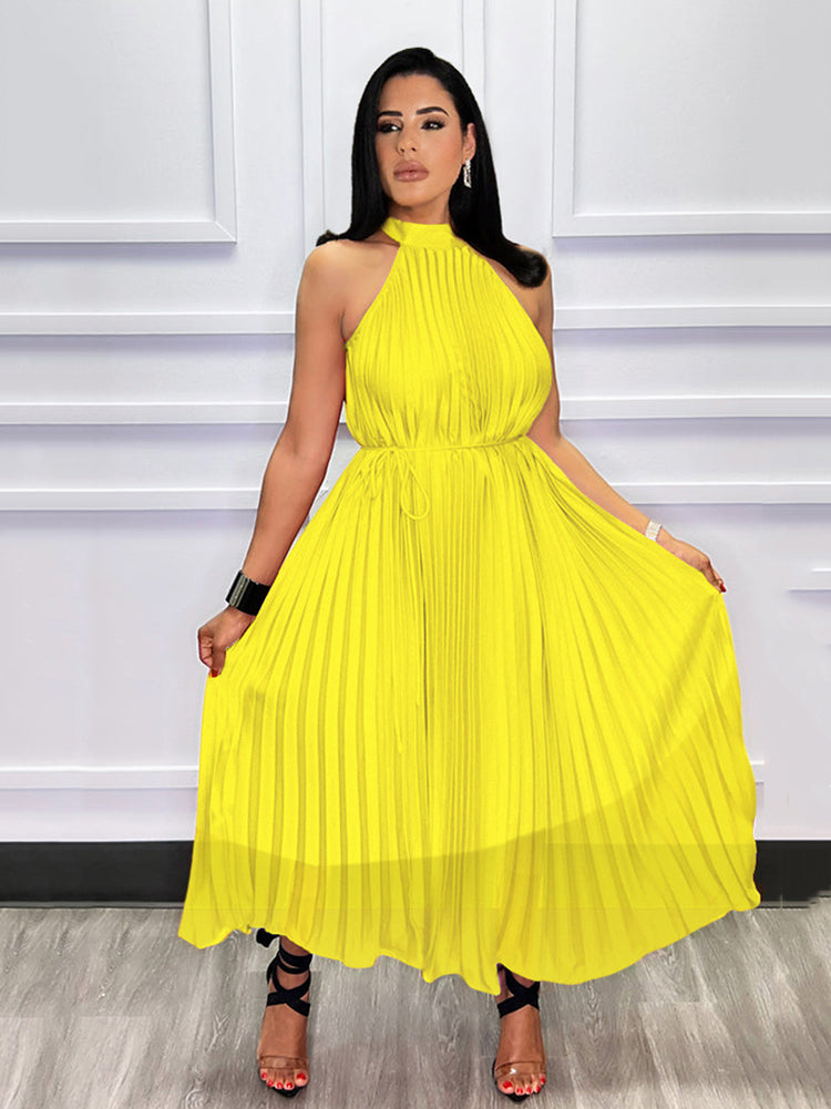 Woman showcasing a yellow pleated halter dress
