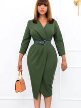 Woman wearing a green wrap dress with a notched lapel and belted waist