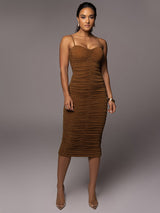 Woman wearing a brown ruched sparkly knit midi dress with spaghetti straps.
