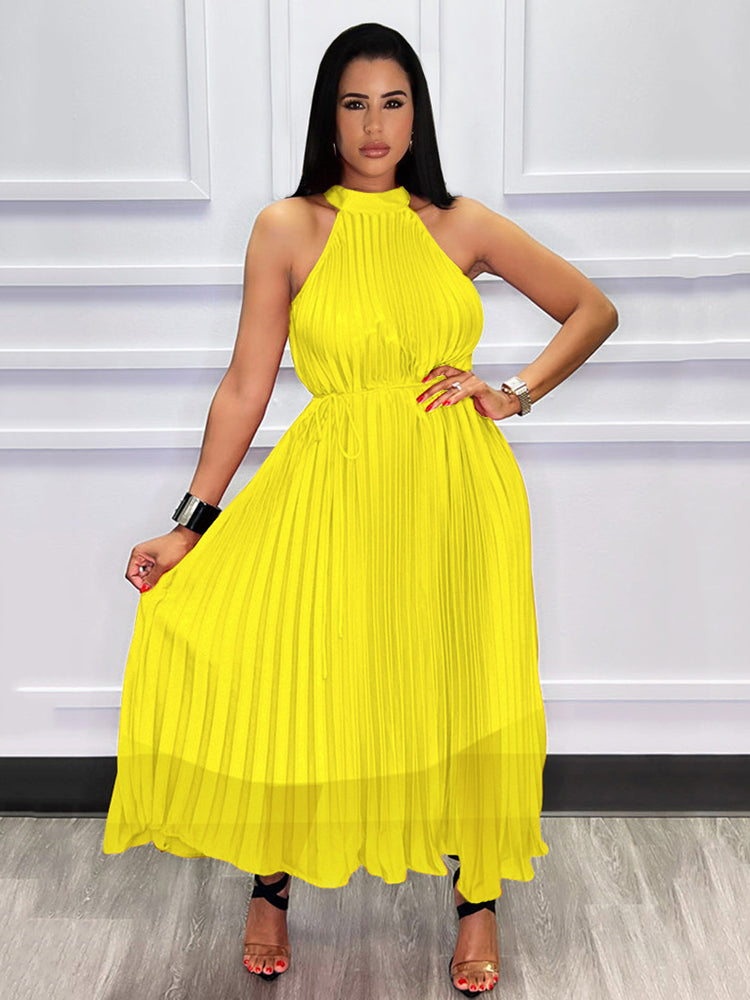 Woman wearing a yellow pleated halter dress