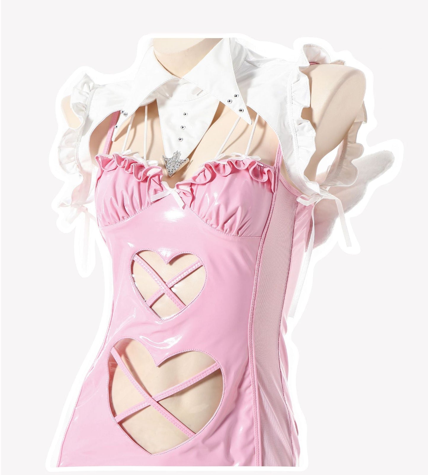 Close-up of pink patent mini dress bodice with harness detail, cut-outs, bows, and ruffled collar.