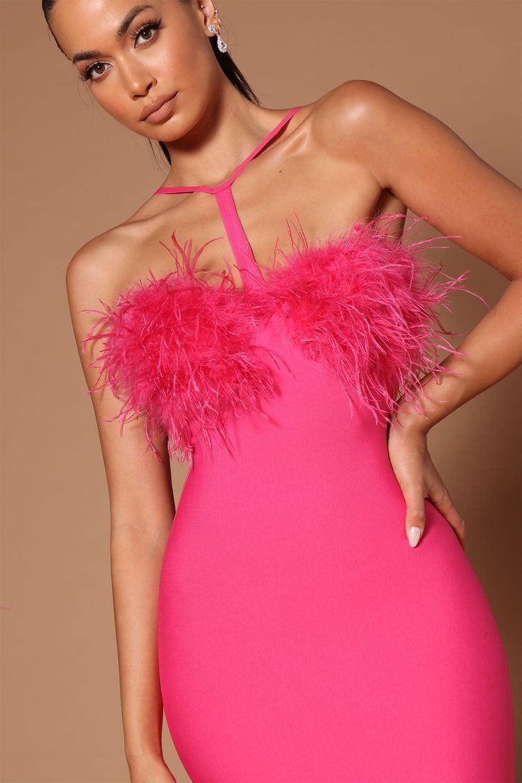 Detailed view of the feather trim on a hot pink bandage dress