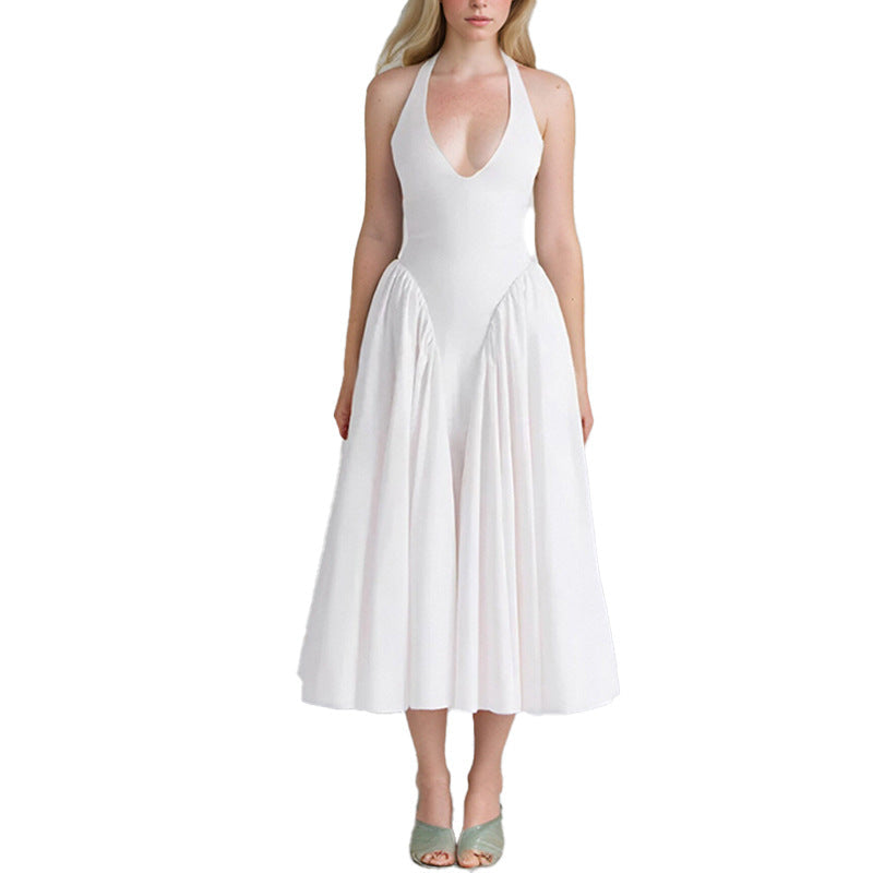 Front view of a woman in a white halter neck midi dress with a voluminous skirt.