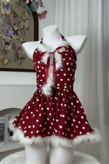 front view of a red and white polka dot halter dress with faux fur trim