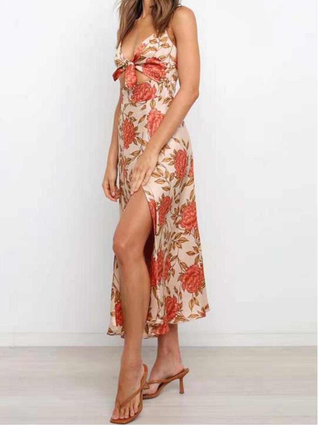 Side view of a woman in a floral print midi dress showcasing the high slit.