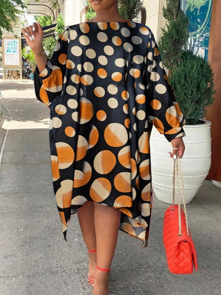 Woman wearing a black and orange polka dot midi dress with a red handbag