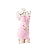 Pink patent mini dress with harness detail, cut-outs, bows, and ruffled collar, side view.